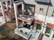 Aerial view of a balcony with a grill and dining table, alongside a patio with a seating area at 8855 E 55Th Ave, Denver, CO 80238