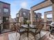 Balcony boasts stylish outdoor dining with a modern rug and pleasant neighborhood views at 8855 E 55Th Ave, Denver, CO 80238