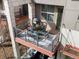 Top-down view of the balcony with outdoor dining set, gas grill, and stylish decor at 8855 E 55Th Ave, Denver, CO 80238