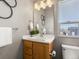 Well-lit bathroom showcasing a modern vanity, a toilet, and stylish decor at 8855 E 55Th Ave, Denver, CO 80238