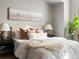Elegant bedroom showcasing a plush bed, decorative pillows, and contemporary bedside lighting at 8855 E 55Th Ave, Denver, CO 80238
