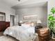 Bright bedroom featuring neutral walls, a cozy bed with plush pillows, and stylish decor at 8855 E 55Th Ave, Denver, CO 80238