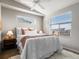 Bright bedroom with a large window, cozy bed, and stylish decor at 8855 E 55Th Ave, Denver, CO 80238