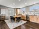 Dining area adjacent to the kitchen, featuring a table with six chairs and natural light at 8855 E 55Th Ave, Denver, CO 80238