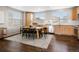 Bright dining area features a table with six chairs, wood floors, and ample natural light at 8855 E 55Th Ave, Denver, CO 80238