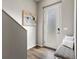 Inviting entryway with stylish flooring, a modern door, and a comfortable bench seating at 8855 E 55Th Ave, Denver, CO 80238