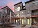 Modern townhomes with unique architectural details and private balconies under a colorful sunset at 8855 E 55Th Ave, Denver, CO 80238