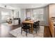 Open concept living room with dining area, gray sofa, dark wood floors and ceiling fan at 8855 E 55Th Ave, Denver, CO 80238
