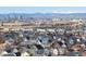 Expansive view of a residential neighborhood and skyline backed by distant, snow-capped mountains at 8855 E 55Th Ave, Denver, CO 80238