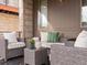 Close-up of a relaxing patio with a cushioned seating arrangement and stylish decorative accents at 8855 E 55Th Ave, Denver, CO 80238