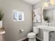 Stylish powder room features modern fixtures, pedestal sink, and tasteful decor at 8855 E 55Th Ave, Denver, CO 80238