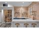 Modern bar area with light wood paneling, bar seating, and open shelving at 1085 S Cook St, Denver, CO 80209