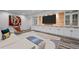 Finished basement with stylish decor, a mounted television, and sleek cabinetry at 1085 S Cook St, Denver, CO 80209