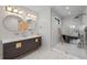 Modern bathroom featuring a double sink vanity, modern tile, and a luxurious black soaking tub at 1085 S Cook St, Denver, CO 80209