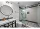 Bathroom featuring walk-in shower with hexagon floor tiles and modern vanity at 1085 S Cook St, Denver, CO 80209