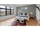 A stylish bedroom featuring modern geometric wall design, and large windows for natural light at 1085 S Cook St, Denver, CO 80209