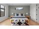 A stylish bedroom featuring modern geometric wall design, and large windows for natural light at 1085 S Cook St, Denver, CO 80209