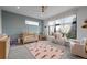 Bright Bedroom with geometric wallpaper accent wall, gray carpet, and ceiling fan at 1085 S Cook St, Denver, CO 80209