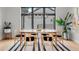 Modern dining room with hardwood floors, designer light fixture, and large windows at 1085 S Cook St, Denver, CO 80209