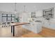 Open-concept kitchen with island, counter seating, modern cabinets, and herringbone backsplash at 1085 S Cook St, Denver, CO 80209