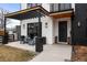 Inviting front porch with pergola, comfortable seating, and stylish exterior lighting at 1085 S Cook St, Denver, CO 80209