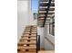 Bright staircase featuring wood treads and black metal railing, with a modern and open design at 1085 S Cook St, Denver, CO 80209