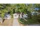 Inviting one-story home surrounded by mature trees, showcasing its cozy charm and curb appeal at 60 Vrain St, Denver, CO 80219