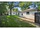 Spacious backyard with lush lawn and storage building with lighting, perfect for outdoor activities at 60 Vrain St, Denver, CO 80219