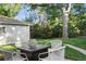 Backyard with an outdoor dining space with seating and large tree at 60 Vrain St, Denver, CO 80219
