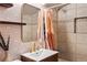 Updated bathroom featuring tile wallpaper, modern light fixture, gold hardware, and shower/tub combination at 60 Vrain St, Denver, CO 80219