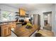 Bright kitchen with wooden cabinets, stainless steel appliances, an island, and a seamless flow into adjacent spaces at 60 Vrain St, Denver, CO 80219