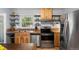 Functional kitchen featuring wooden cabinetry, stainless steel appliances, and open shelving for easy access to essentials at 60 Vrain St, Denver, CO 80219
