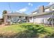 Cozy backyard features a well-maintained lawn, a patio area, and mature trees for shade and privacy at 1624 S Elizabeth St, Denver, CO 80210