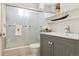 Well-lit bathroom with a shower, frosted glass door, and updated vanity at 1624 S Elizabeth St, Denver, CO 80210