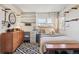 Comfortable bedroom with a bed, desk, dresser, and natural light at 1624 S Elizabeth St, Denver, CO 80210