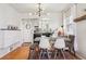View of the dining room featuring wood floors, an updated light fixture and access to the kitchen at 1624 S Elizabeth St, Denver, CO 80210