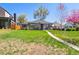 Charming home with a well-manicured lawn, mature trees, and inviting curb appeal at 1624 S Elizabeth St, Denver, CO 80210