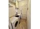 Functional laundry room featuring a washing machine, and convenient upper cabinet storage at 1624 S Elizabeth St, Denver, CO 80210