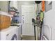 Functional laundry room with a white washer and dryer at 1624 S Elizabeth St, Denver, CO 80210