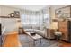 Bright living room featuring hardwood floors, large windows, and a comfortable sectional sofa at 1624 S Elizabeth St, Denver, CO 80210
