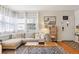 Comfortable living room featuring a sectional sofa, coffee table, and view of front door at 1624 S Elizabeth St, Denver, CO 80210