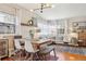 Inviting living room and dining area with a table and chairs, hardwood floors, and large windows at 1624 S Elizabeth St, Denver, CO 80210
