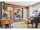 Multi-purpose room with a piano, desk, and a custom bookshelf at 1624 S Elizabeth St, Denver, CO 80210