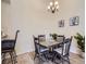 Cozy dining room with a wood table, cushioned chairs, and a decorative chandelier at 6332 Zang Court # A, Arvada, CO 80004