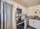 Updated kitchen with granite counters, white cabinets, and stainless steel appliances at 6332 Zang Court # A, Arvada, CO 80004