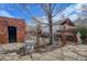 Cozy brick-paved backyard featuring a charming outdoor seating area under the shade of a mature tree at 404 S Grant St, Denver, CO 80209