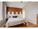 Comfortable bedroom with hardwood floors, brick accent wall, and white trim at 404 S Grant St, Denver, CO 80209