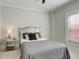 Cozy bedroom featuring a mirrored headboard, neutral bedding, and a window with bright natural light at 404 S Grant St, Denver, CO 80209