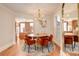 Elegant dining room featuring a round table with modern orange chairs and a stylish chandelier at 404 S Grant St, Denver, CO 80209