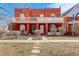 Charming red brick two-story home with a spacious front porch and manicured lawn at 404 S Grant St, Denver, CO 80209